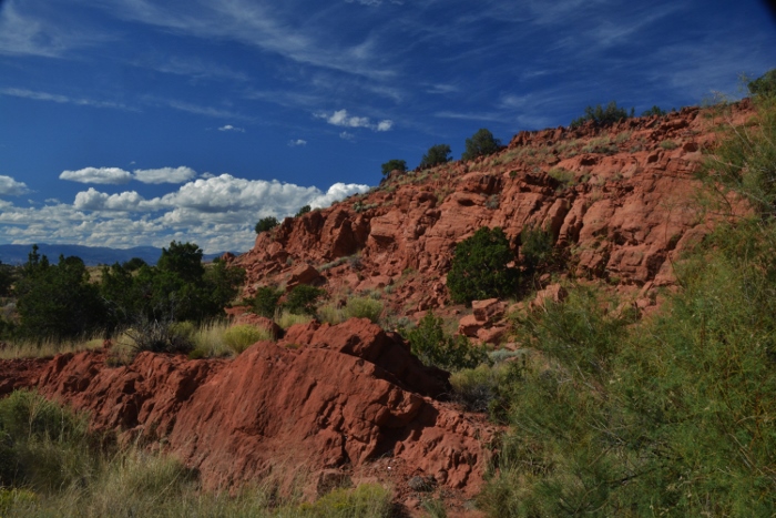 Red rock alongside road